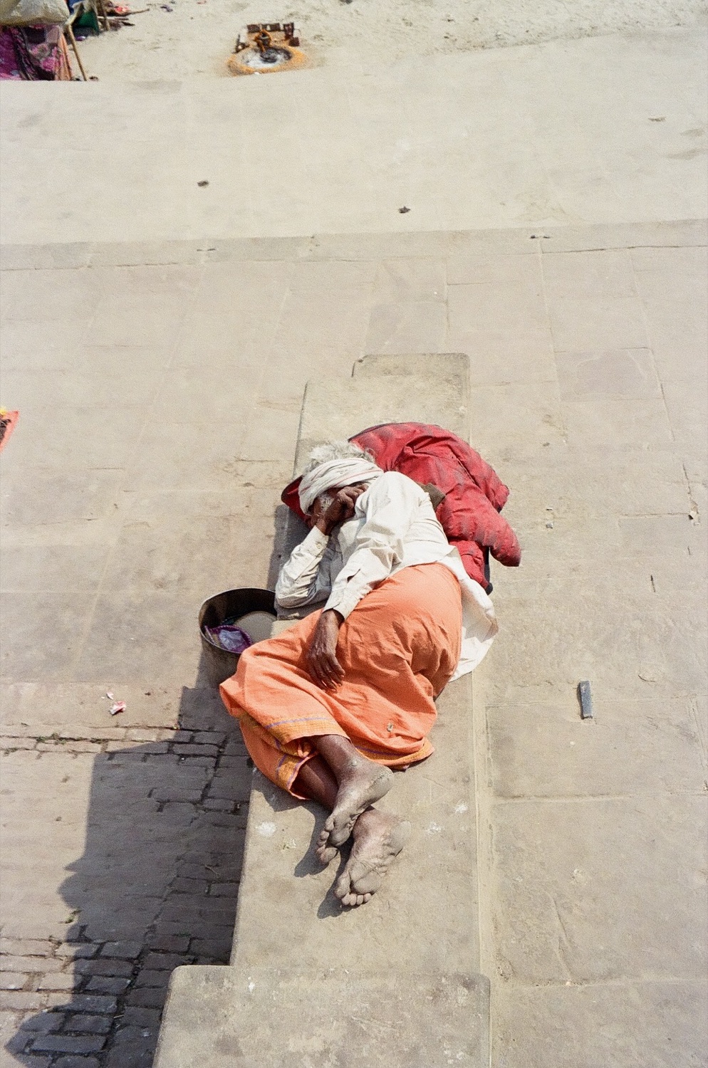 A sadhu asleep on the ghat steps